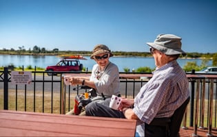 Riverside Holiday Resort Urunga's return guests Helen and Kevin enjoy the riverside view with their morning coffee.